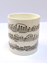 Load image into Gallery viewer, Music gift ideal for classical music fans. Elegant bone china mug with a section of Mendelssohn's Violin Concerto printed on in black. This fabulous mug is perfect for any violin player or music lover. A combination of a full capacity of 310ml and a subtle lip and classic handle design makes this mug both comfortable and stylish. Microwave and dishwasher safe. Height 85mm; Diameter 77mm. View from centre thechord.co.uk