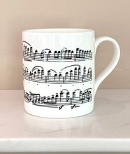 Load image into Gallery viewer, Music gift ideal for classical music fans. Elegant bone china mug with a section of Mendelssohn's Violin Concerto printed on in black. This fabulous mug is perfect for any violin player or music lover. A combination of a full capacity of 310ml and a subtle lip and classic handle design makes this mug both comfortable and stylish. Microwave and dishwasher safe. Height 85mm; Diameter 77mm. View from right thechord.co.uk