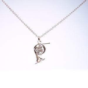 Sterling Silver French Horn necklace. Intricate detailing on both sides of pendant..