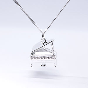 Sterling Silver Grand Piano Necklace. The Grand Piano pendant's intricate details include an accurate keyboard, strings, stand, pedals and lid.