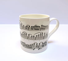 Load image into Gallery viewer, Music gift ideal for classical music fans. Elegant bone china mug with a section of Mendelssohn&#39;s Violin Concerto printed on in black. This fabulous mug is perfect for any violin player or music lover. A combination of a full capacity of 310ml and a subtle lip and classic handle design makes this mug both comfortable and stylish. Microwave and dishwasher safe. Height 85mm; Diameter 77mm. View from right 2 thechord.co.uk