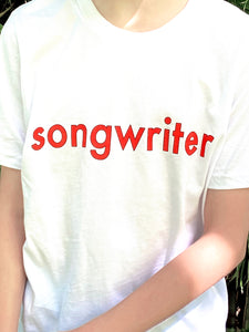 White T-shirt with "songwriter" in red text outlined in black. Shown on model - close up view.