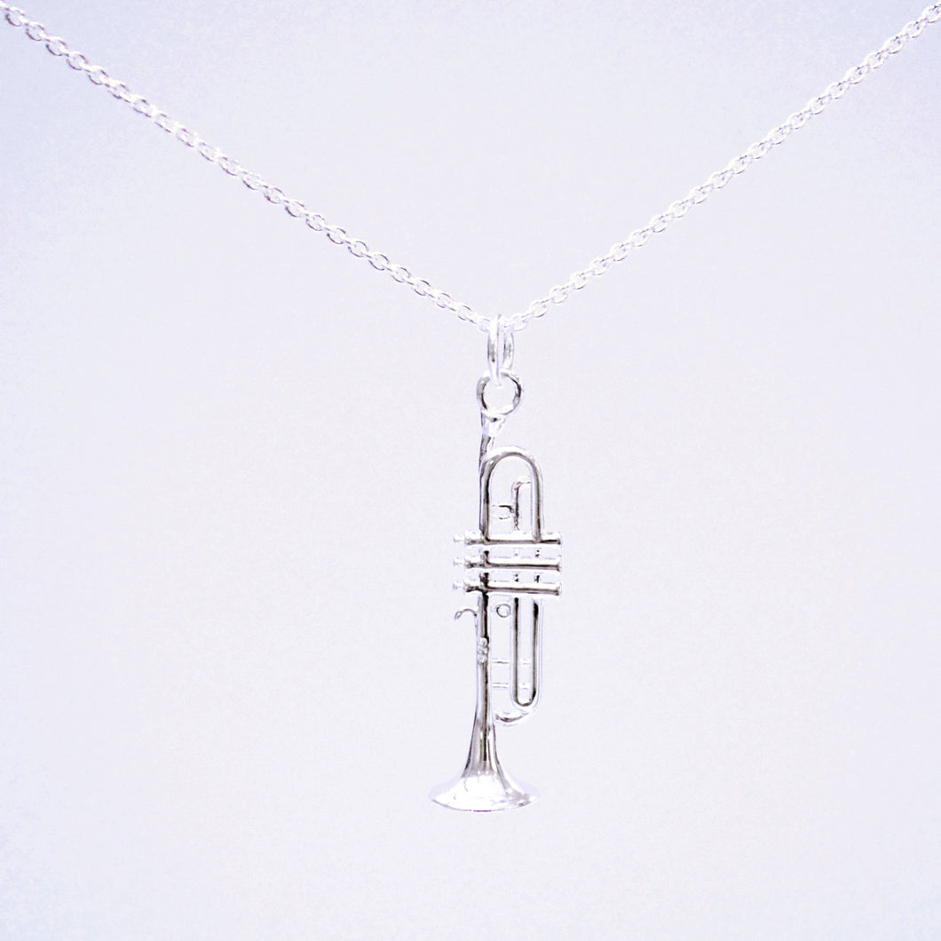 Sterling Silver trumpet pendant necklace. The Trumpet pendant's intricate design includes fine details such as the mouthpiece, valve casings, pistons, third valve slide, tuning slide and bell.